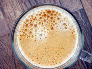 Coffee foam , creamy coffee foam, rich, frothy surface, freshly brewed cup of hot Americano. Top view of Espresso foam closeup. Creamy coffee macro shot