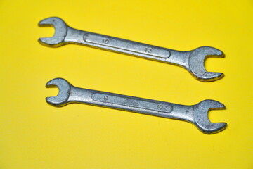 2 fixed spanner wrench isolated on yellow background