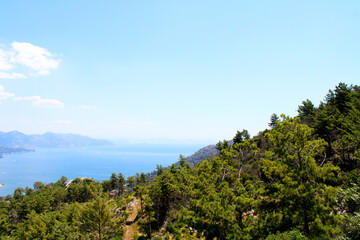 Obraz premium Scenic coastal view with mountains and turquoise water under a bright sky. Marmaris, Mugla, Turkey.