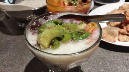 Delicious Indonesian Es Campur Dessert with Avocado and Sweet Beans in a Glass Bowl