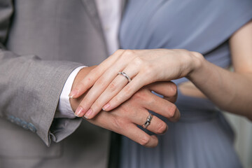 Close-Up of a Couple's Hands with Wedding Rings, Symbolizing Love and Commitment.
