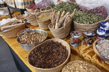 Fototapeta premium Colorful spices and incense displayed on market stall