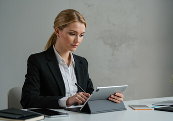 Young businesswoman working on tablet in modern office setting  