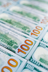 a lot of money banknotes of one hundred 100 American dollars lie on the table evenly laid out, the background is littered with money American green dollars, wealth