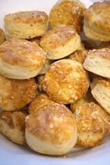 Freshly baked Hungarian cheese scones served in bowl, traditional homemade pastry close-up.