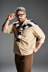 Stylish man in glasses showcasing contemporary elegance in a modern studio setting