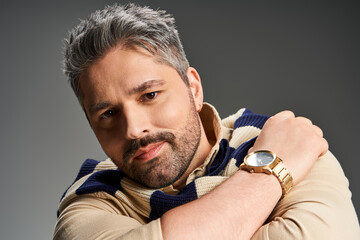 Stylish man with bristle showcases modern fashion in a studio setting