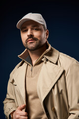 Handsome man in stylish bristle look showcasing trendy fashion in modern studio setting