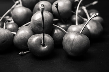 lots of cherries on a black background, black and white