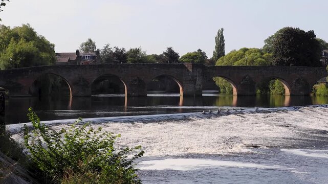 bridge in dumfries with river nith running through the scene