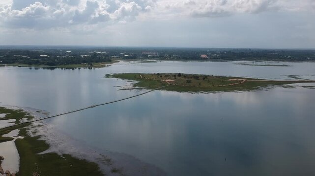 Aerial Drone View of Phutthachai Reservoir at Buddhist Park, Amnat Charoen, Thailand, Perfect for travel, tourism, cultural, and documentary projects.