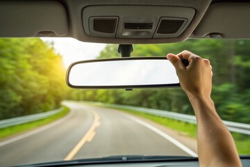 Rearview Mirror Adjustment: Hand Adjusting Car Mirror on Scenic Road Trip
