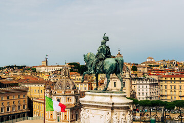 Bronze equestrian statue of Vittorio Emanuele II at Altare della Patria in Rome, Italy, overlooking domes and colorful rooftops