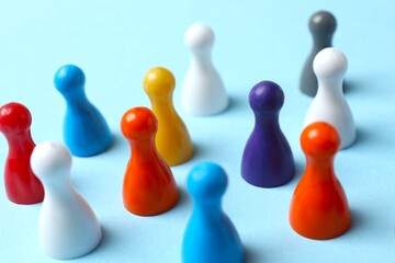Colorful pawns on light background. Concept of Diversity, Inclusion and Equality, space for text