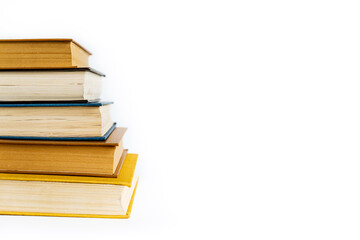 many old vintage tired worn books of yellow, blue, brown colors lie on white background with space for text, stack of books in library