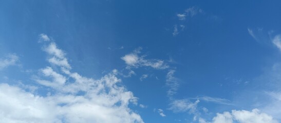 Clear Blue Sky with White Clouds Background