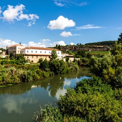 Obraz premium River view of Spanish countryside building
