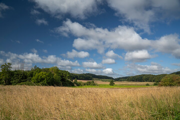Blue sky with white clouds shines over Danish landscape