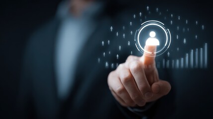 Finger touches glowing person icon, dark jacket, data graphics in background