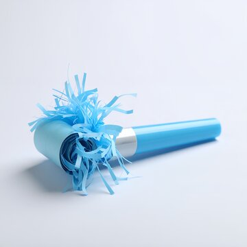 Celebratory turquoise noisemaker with festive streamers for special occasions on white background