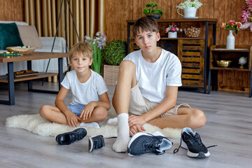 Happy positive children, tickling on the feet, having fun together, boy brothers having wonderful...