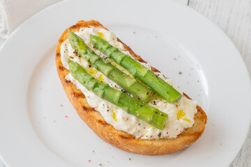 Grilled sandwich with white bread, stracciatella cheese, and green asparagus