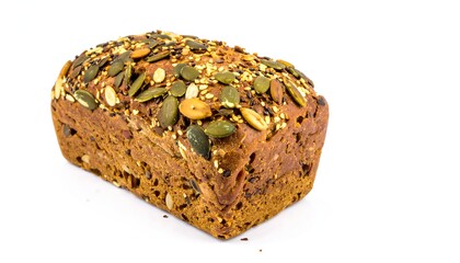 Seeded loaf with pumpkin, sesame, and flax seeds on a white background, showcasing texture and healthy ingredients.