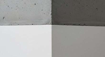 Close-up showcases the intersection of rough, textured concrete and smooth, painted white surfaces, creating a stark contrast in materials, colors, and textures that captures minimalist abstraction.