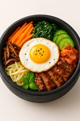 Delicious korean bibimbap with fried egg and fresh vegetables