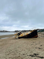 Old fishing schooner in the bay of the Barents Sea, Teriberka, Russia