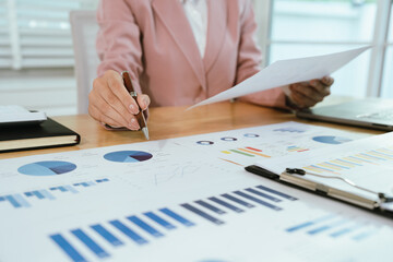 A professional business environment with charts and graphs on a laptop, symbolizing financial analysis, corporate strategy, economic planning, data review, management reporting, growth, consulting, ac