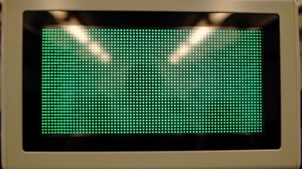 Blank green LED dot matrix display screen showing a glowing pixel grid