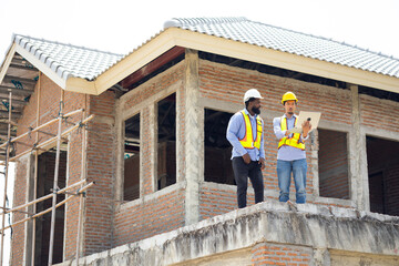 Engineering inspect construction site : construction worker Architects and contractor working together inside building under construction site. Engineering in safety harthat helmet. Engineering team
