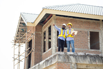 Engineering inspect construction site : construction worker Architects and contractor working together inside building under construction site. Engineering in safety harthat helmet. Engineering team