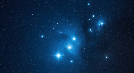 The Pleiades star cluster, also known as the Seven Sisters, shining brightly in the deep blue night sky. A beautiful astronomical view of a starfield and constellation.
