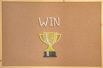 A creative concept image of a trophy cup and the word “WIN” designed with colorful push pins on a corkboard. The composition symbolizes victory, achievement, motivation, competition, and success. 