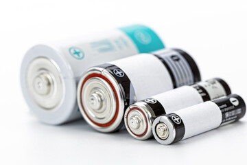Various size battery cylindrical battery alkaline battery rechargeable battery power supply energy storage close up metallic white background technology concept