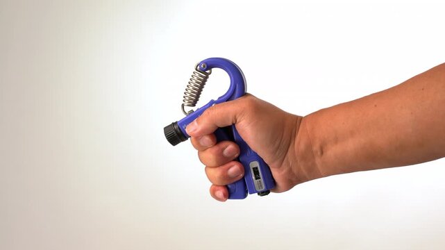 A hand using blue hand grip strengthener for exercise, rehabilitation, and building hand strength, holding blue hand strengthener adjustable grip exerciser for muscle training, physical therapy tool