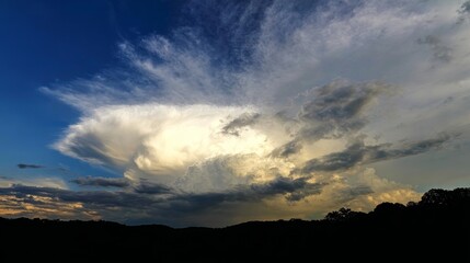 Dramatic evening thunderstorm cloud formation with glowing bubbling thunderhead beneath dark streaks of sky, symbolizing power, instability, turbulence and aviation weather alerts