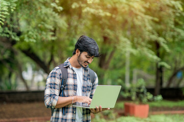 Fototapeta premium Young Male College Students With Laptop and books
