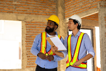 Engineering inspect construction site : construction worker Architects and contractor working together inside building under construction site. Engineering in safety harthat helmet. Engineering team