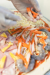 Pizza waiting to be baked outside the oven