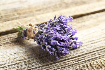 Fototapeta premium Bunch of beautiful lavender flowers on wooden table, closeup