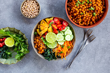 Buddha bowl - vegetarian bowl with chickpeas and fresh vegetables on the grey background top view