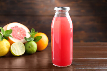 Tasty juice in glass bottle, fresh fruits and mint on wooden table, selective focus