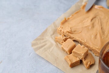Making candies. Homemade caramel dessert on light table, closeup. Space for text