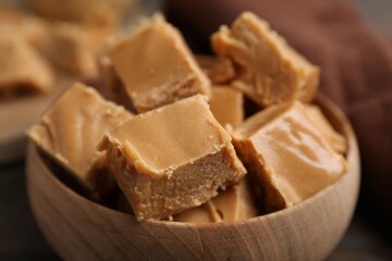 Homemade caramel candies in bowl on table, closeup
