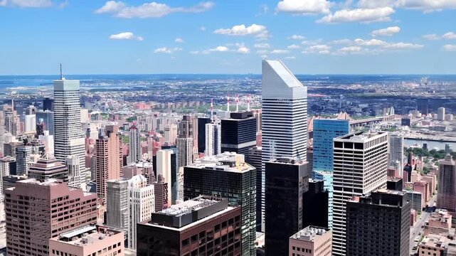 Manhattan, New York City. Aerial view of a cityscape with skyscrapers and a river, showcasing a blend of modern and traditional architecture. The cityscape is dominated by highrise buildings.