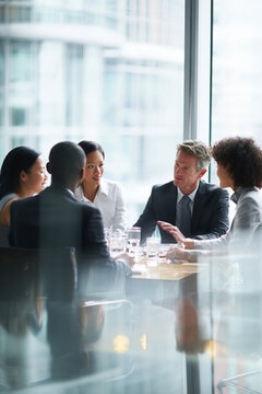 Business men and women wearing suit or formal outfit, discussing at their meeting with co-worker and client at   modern office in urban building. 