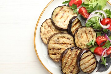 Grilled slices of eggplant with salad on white wooden table, top view. Space for text